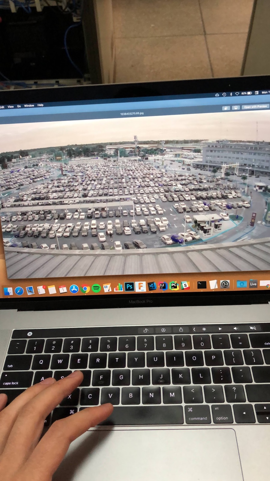 A dewarped fisheye frame of an airport parking lot open on a laptop.
